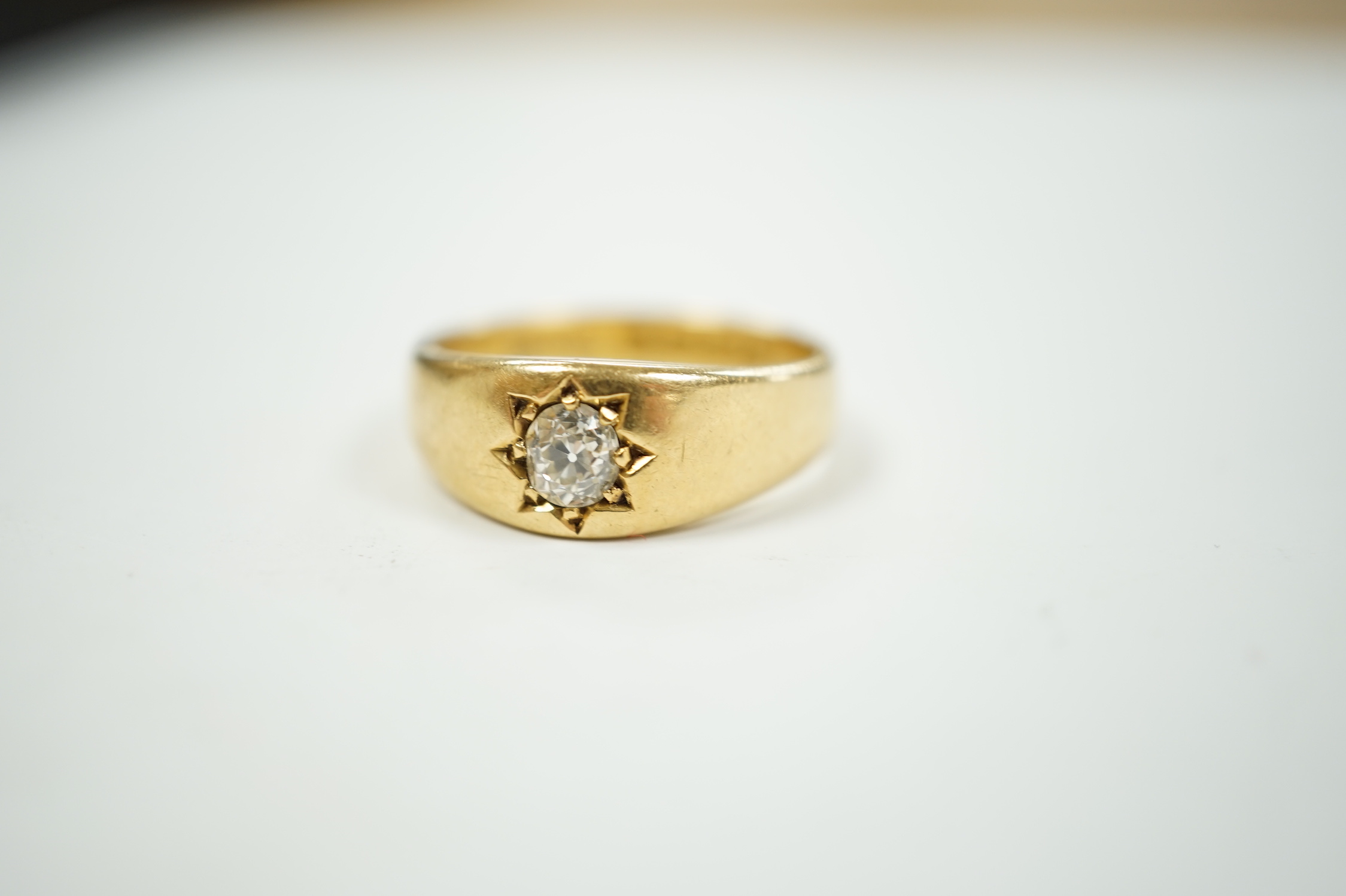 A late Victorian 18ct gold and gypsy set solitaire diamond ring, size Q, gross weight 7.5 grams.